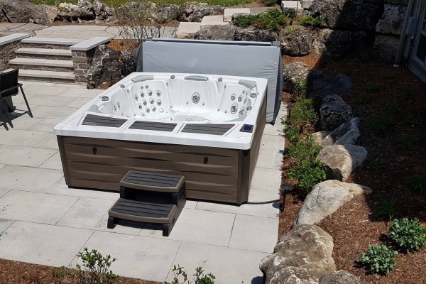 Kingston hot tub from Sundance Spas installed in a backyard space.