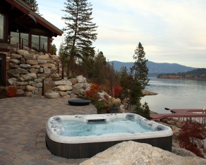 Outdoor hot tub installation by the water in the fall.