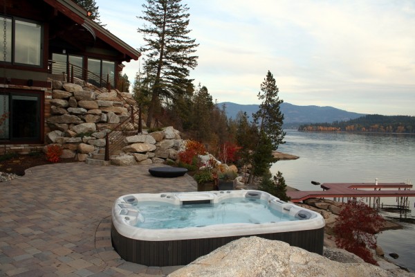 Outdoor hot tub installation by the water in the fall. Outdoor hot tub installation by the water in the fall.