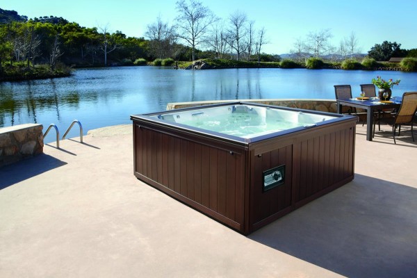 Outdoor hot tub installation by the water. Outdoor hot tub installation by the water.