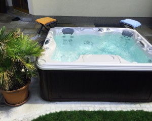 Outdoor hot tub installation on a patio in the spring.