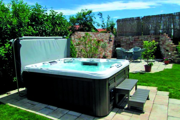 Outdoor hot tub installation on a patio in the spring. Outdoor hot tub installation on a patio in the spring.