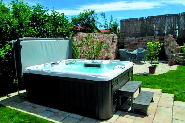 Outdoor hot tub installation on a patio in the spring.