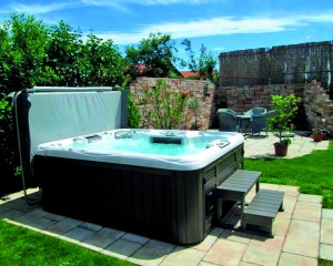 Outdoor hot tub installation on a patio in the spring.