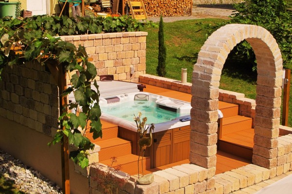 Beautiful and sunny outdoor hot tub installation. Beautiful and sunny outdoor hot tub installation.