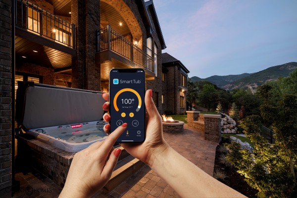 Person using a mobile device to control the SmartTub System.