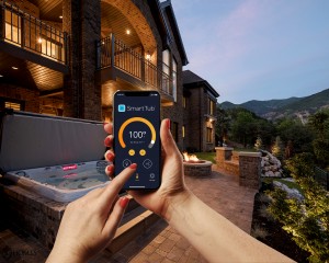 Person using a mobile device to control the SmartTub System.