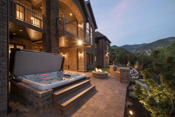 Hot tub outside of mansion at dusk.