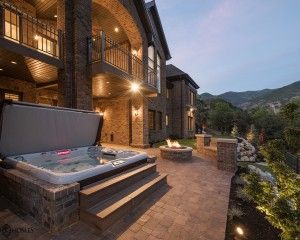 Hot tub outside of mansion at dusk.