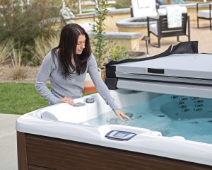 Woman feeling the water in her hot tub.